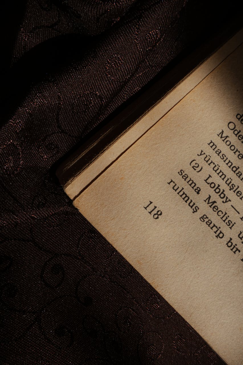 The corner of an opened book with slightly yellowed pages